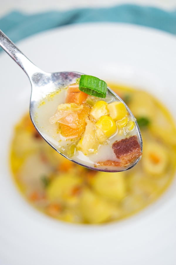 Close up of instant pot potato corn chowder on a spoon.