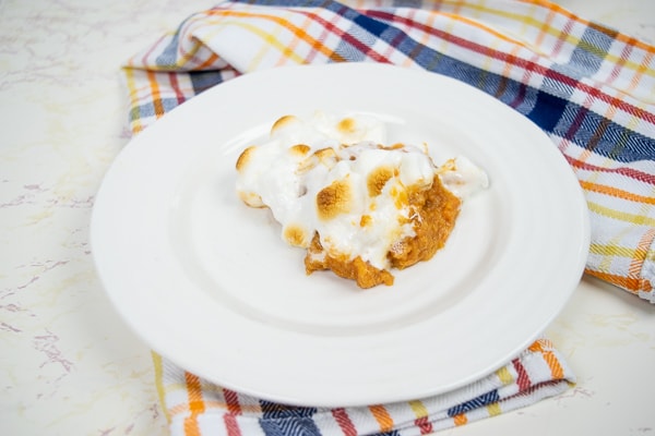 Instant pot sweet potato casserole served on a round white plate.
