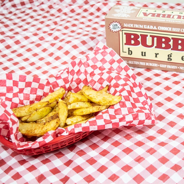A bowl of zesty fries next to a BUBBA burgers box.