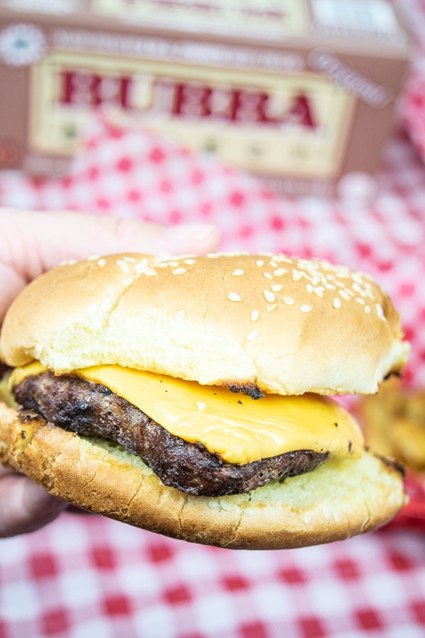 Close up of a BUBBA burger grilled up and topped with cheese and bun.