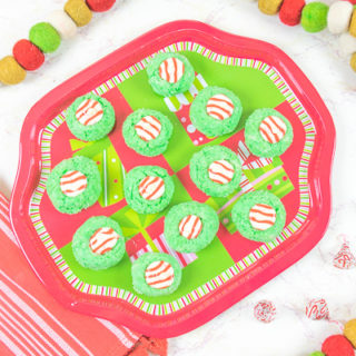 A plate full of green and red Christmas cookies.