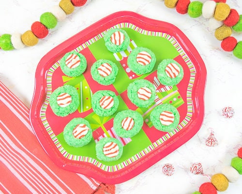 A plate full of green and red Christmas cookies.