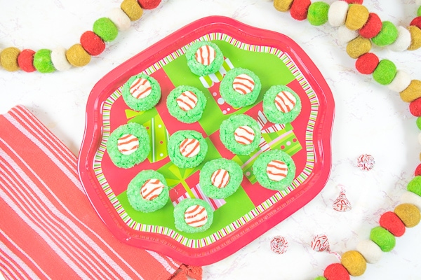 A plate full of green and red Christmas cookies.