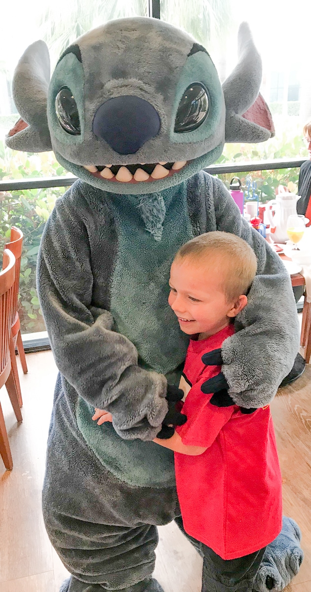 A boy hugging stitch during his Disneyland character breakfast.