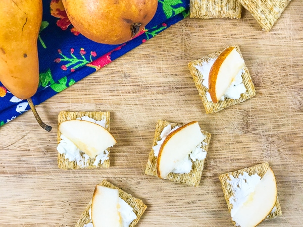 Goat cheese appetizers topped with sliced Asian pears.