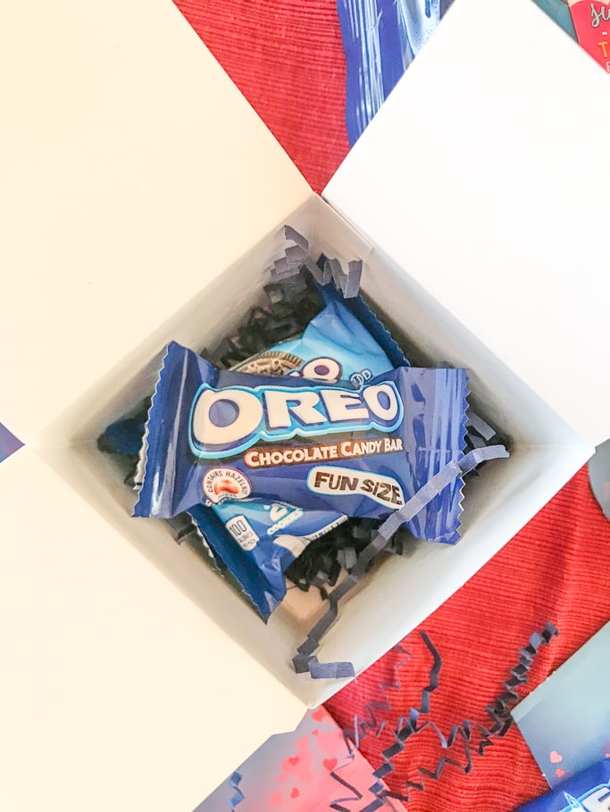 A white box with OREO cookie packs inside.