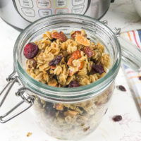 A close up of instant pot granola made with rolled oats, almonds, and dried cranberries