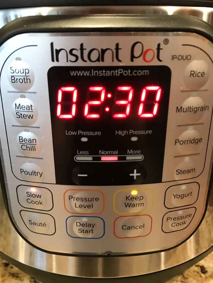 The front of an Instant Pot with the timer set to 2 hours 30 minutes.