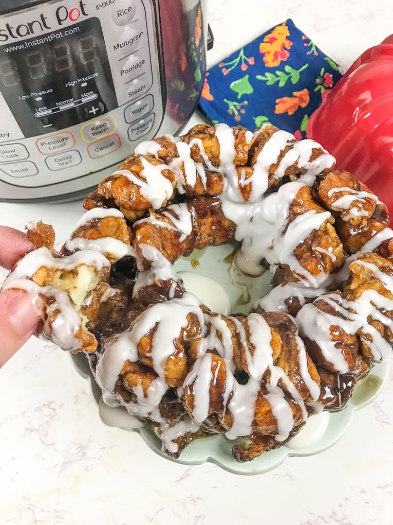 A hand pulling off a piece of instant pot monkey bread.
