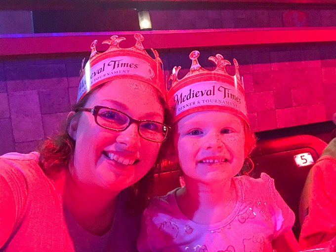 A woman and child wearing crowns at Medieval Times Buena Park.