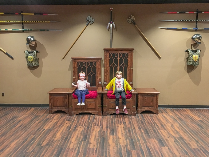 Two kids sitting in the king and queen thrones at Medieval Times Buena Park.