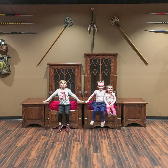 Three kids sitting on thrones at Medieval Times in Buena Park.