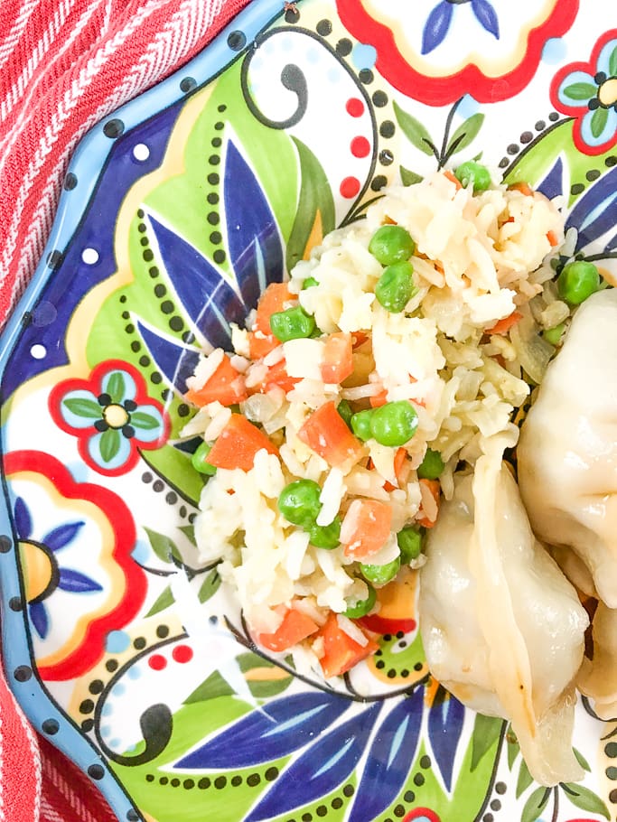 A colorful plate filled with vegetable fried rice.