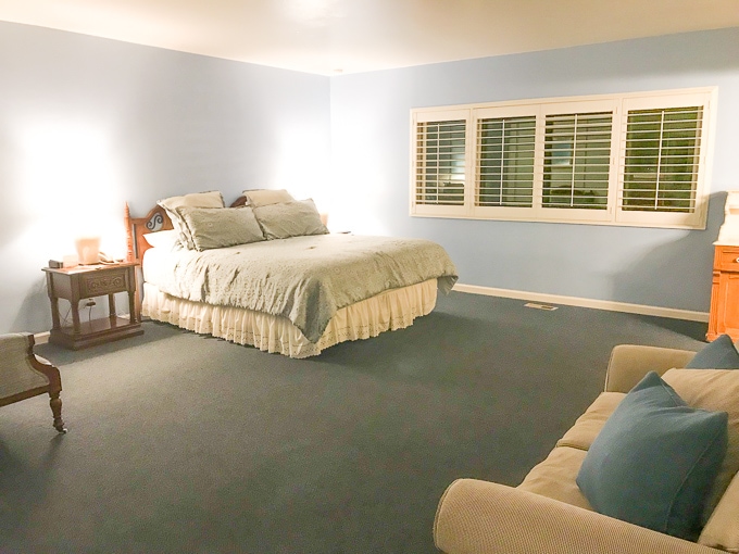 The first room in the two room suite at Hofsas House, featuring a king sized bed with light blue duvet.