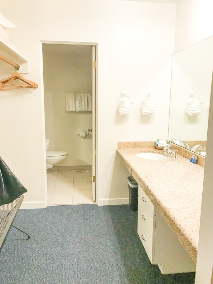 The master bathroom in the two room suite at Hofsas House featuring two sinks and a long counter.