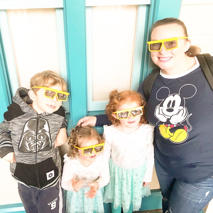 A mom and her three kids in line for the Toy Story Mania ride at California Adventure.