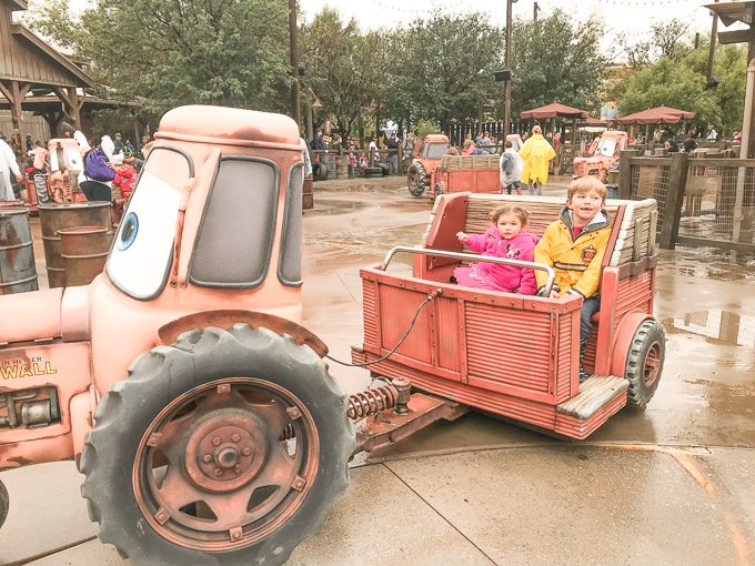 A boy and girl riding Mader's Junkyard Jamboree in California Adventure during Winter.