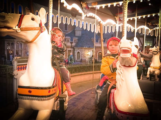 Two kids on the Carousel at Disneyland in Winter.