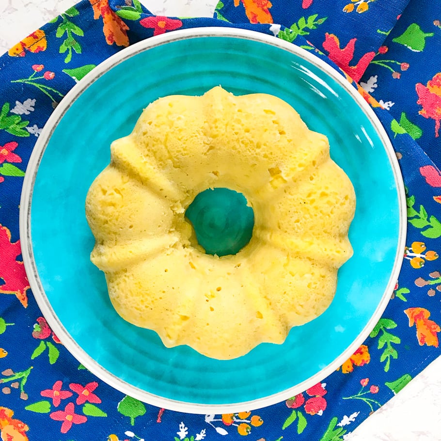 instant pot cornbread on a blue plate over a blue and red floral towel.