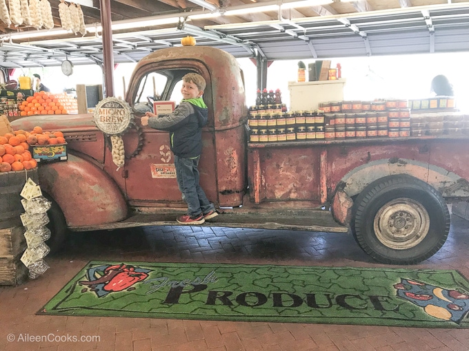 A boy on the truck inside Casa de Fruta fruit stand.