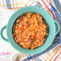 A teal bowl filled with instant pot baked beans.
