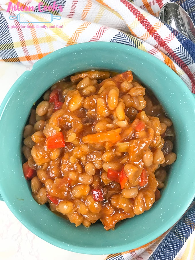 An overhead shot of a teal bowl filled with instant pot baked beans.