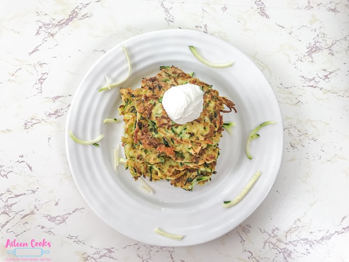 Zucchini fritters on a white plate.