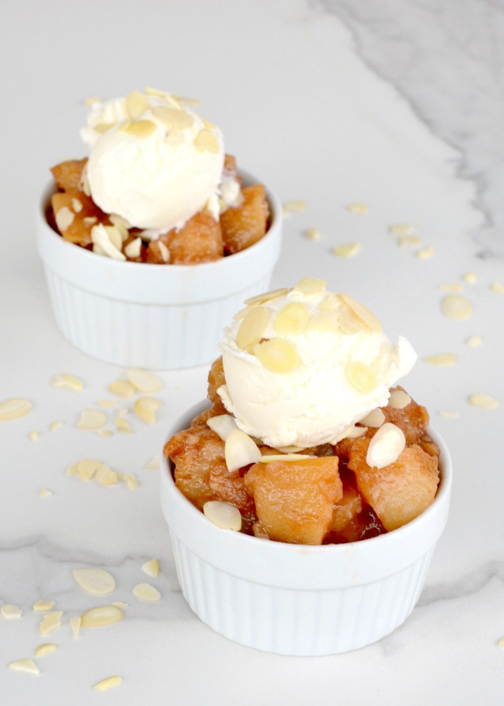 Apple pie filling is an easy instant pot apple dessert recipe shown topped with vanilla ice cream.