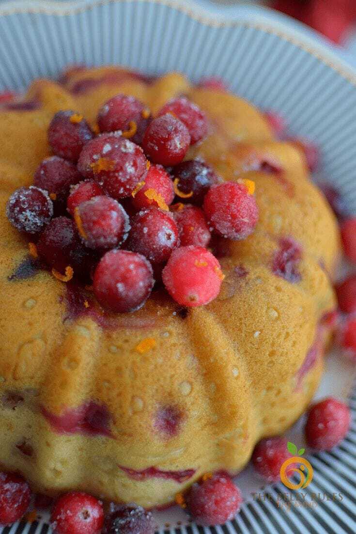 Close up of a Bundt Cake topped with cranberries.