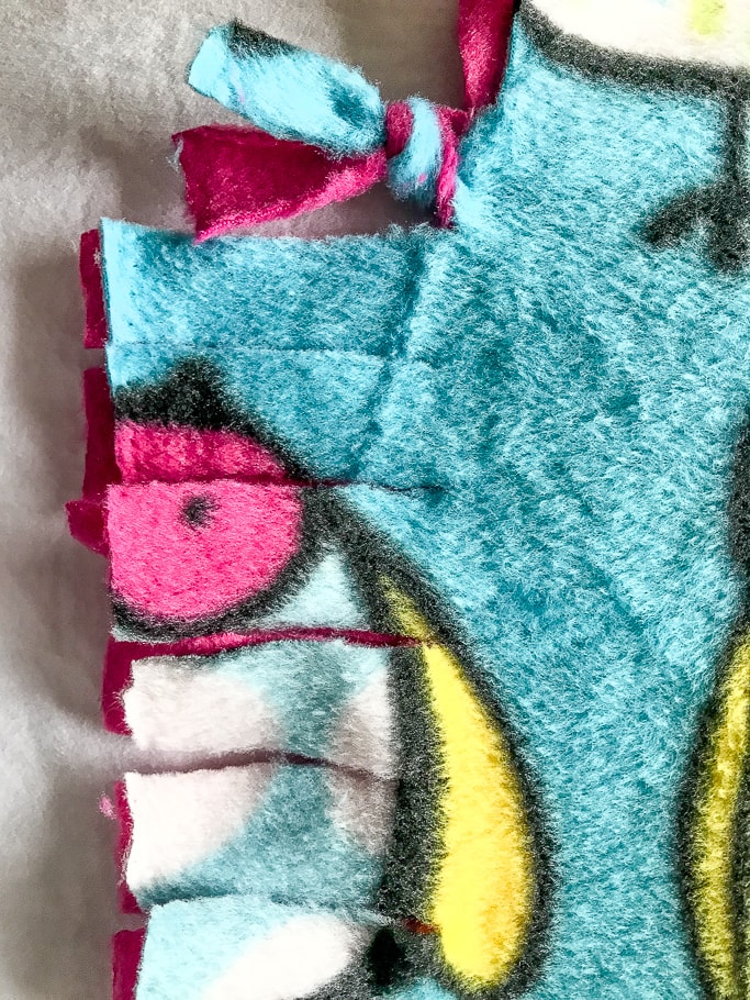 Close up of slits made for fleece tie blanket.