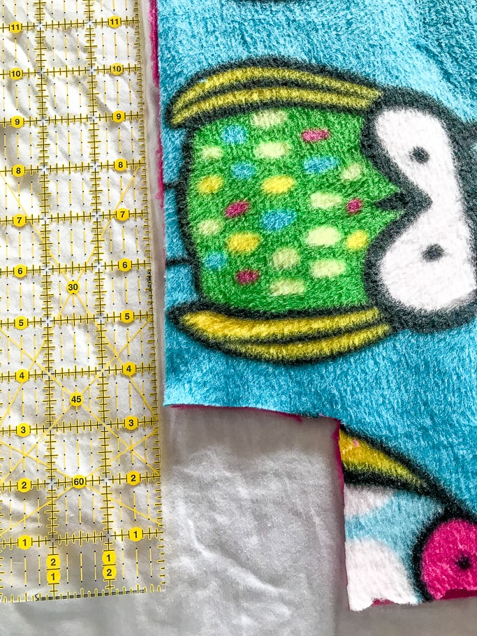 Owl fleece fabric next to a ruler.