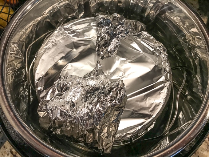 Peach cobbler wrapped in foil and inside Instant Pot.