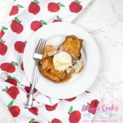 A white plate of apple dumplings with a fork.