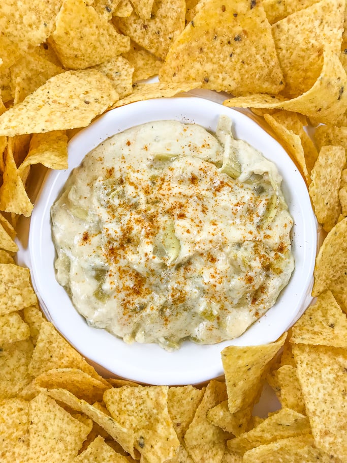 A close up of instant pot artichoke dip in a white bowl.