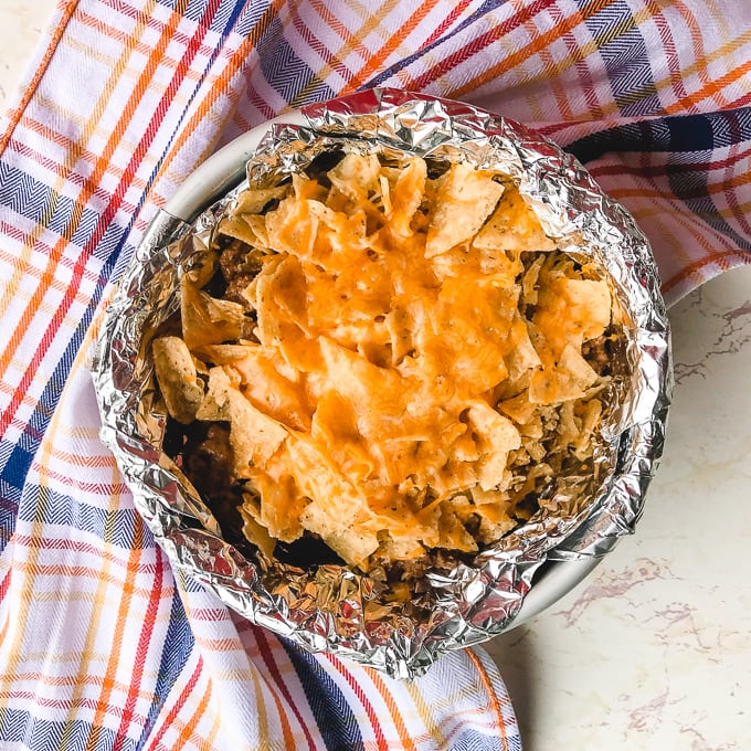 instant pot taco casserole in a round dish and surrounded by a striped towel.