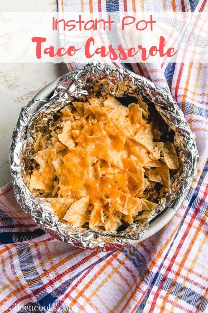 A round foil-lined baking dish filled with instant pot taco casserole.