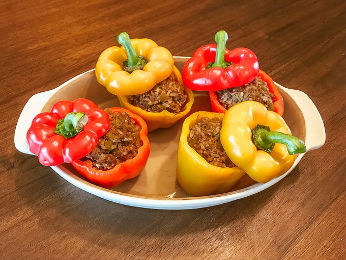 A dish filled with four instant pot taco stuffed peppers.