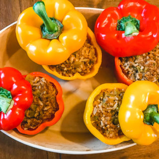 4 instant pot taco stuffed peppers in a serving dish.