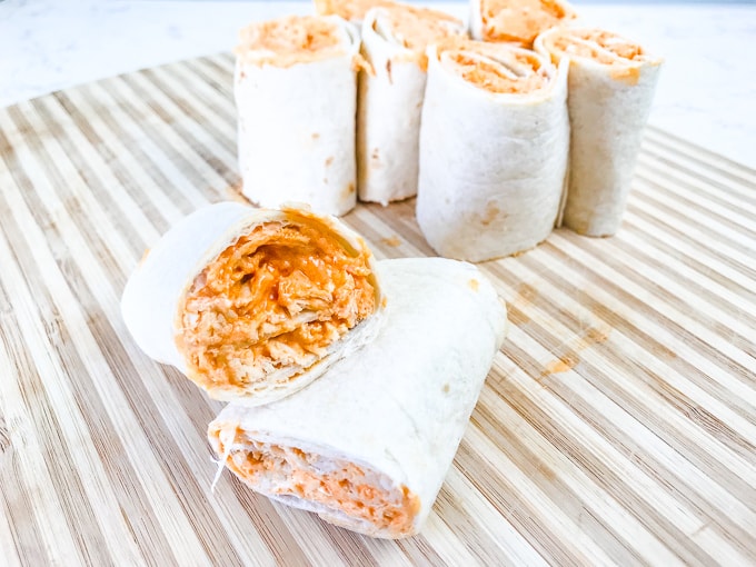 Two buffalo chicken roll ups stacked sideways on each other.