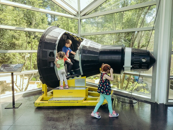Kids climbing inside a rocket ship at Chabot Space and Science Center.