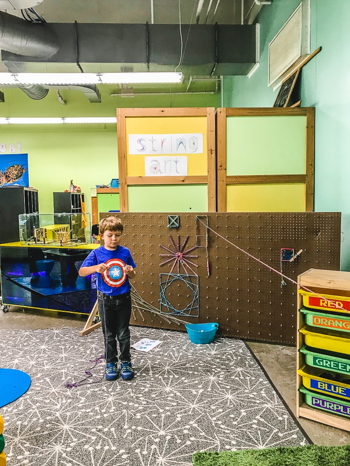 A boy doing string art in Chabot Space & Science Center's Project Create room.