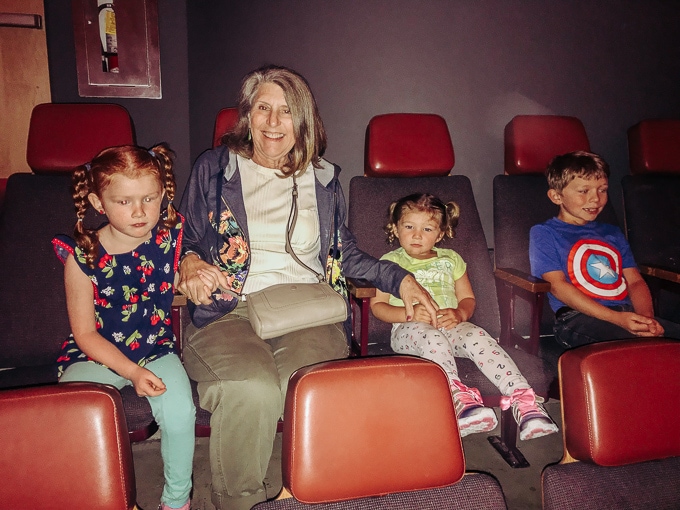 Three kids with their grandma, watching the planetarium show at Chabot Space & Science Center.
