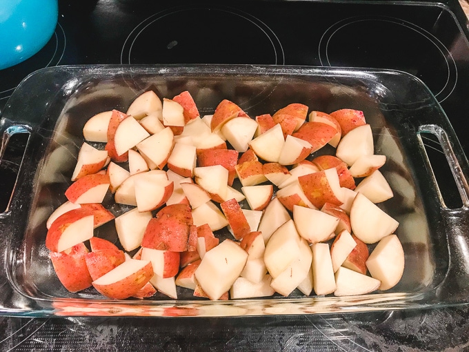 Cut-up red potatoes in a casserole dish.