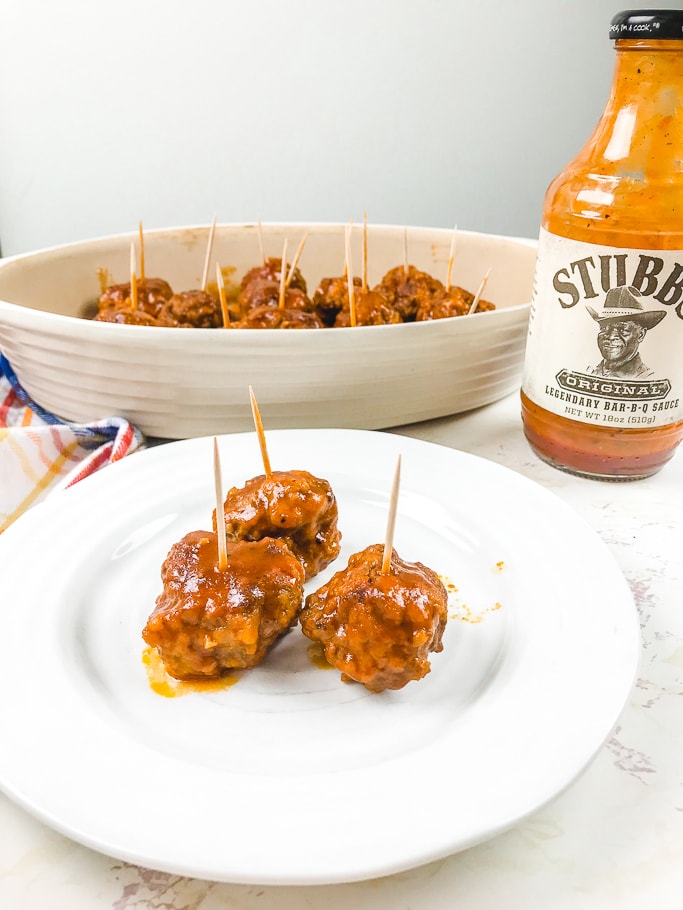 3 instant pot meatballs on a white plate.