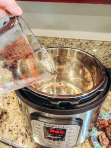 Water being poured into the instant pot.