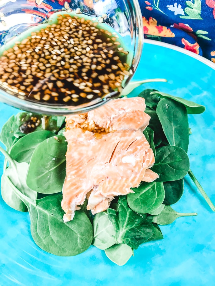 Homemade teriyaki sauce being poured of instant pot salmon.