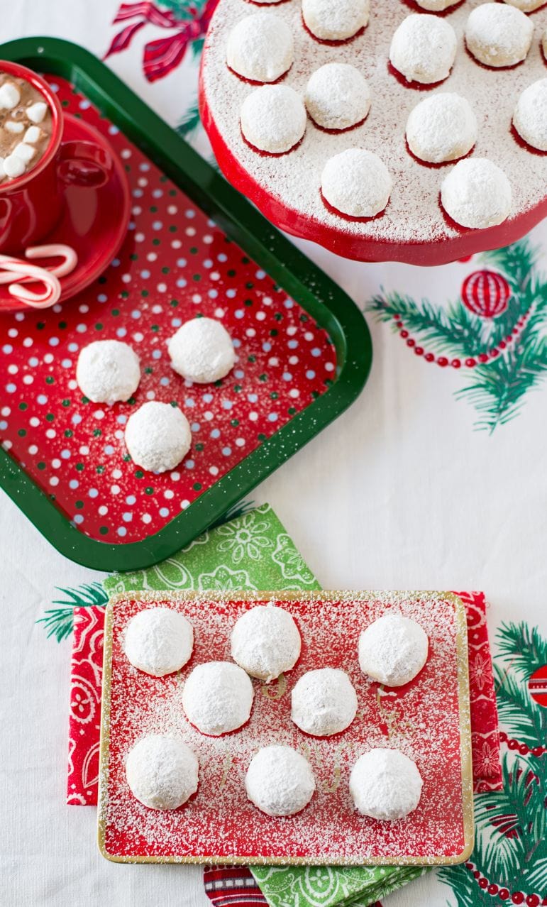 Mexican wedding cookies on festive Christmas background.