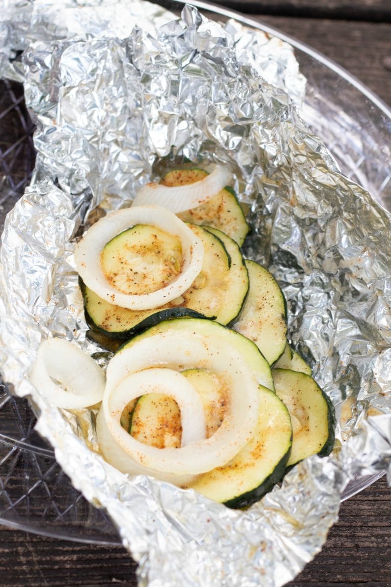 A foil packet with sliced zucchini.