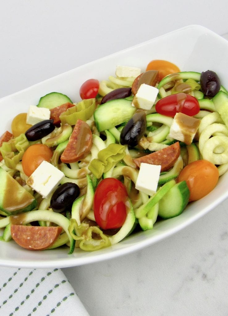 Zucchini pasta salad in a white oval bowl.