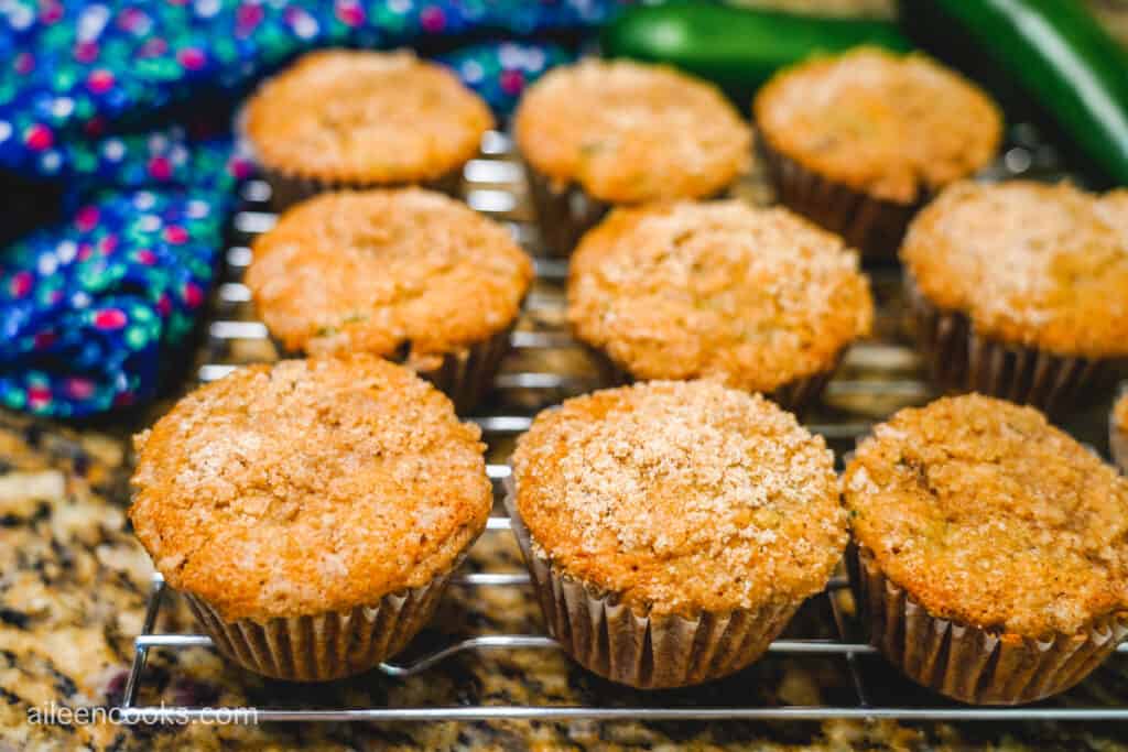 A freshly baked batch of muffins cooling on a wire cooling rack.